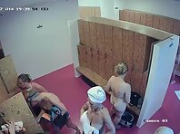 Lo2084#The locker room was filled with women who had completed their sports activities. They