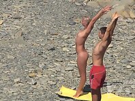 Nu1277#Naked babe and her man doing exercises on a nudist beach. Our operator shoots on a nu