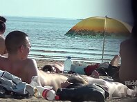 Nu1339#Slender beauty with glasses shows her body at a nude beach. We can see her beautiful 