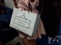 Up2958#Under the skirt of a tanned brunette in a short beige dress. A beautiful ass and shav