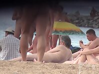 Nu1321#A young pretty woman lights a cigarette at a nudist beach. Excellent model for nude b