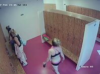 Lo1962#Women return to the locker room after playing sports. They take off their sportswear 