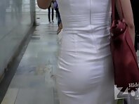 Up2138#Red-haired beauty in a short white dress. Our cameraman filmed close-up of her round 