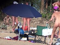 Nu2147#The company is located on the edge of a nudist beach. They have fun chatting, sunbath