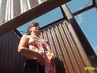 Bc1411#A woman in a closed swimsuit dresses up in beach cabin.