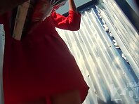 Bc2289#A brunette in a red dress is completely undressed and puts on a swimsuit in a beach c