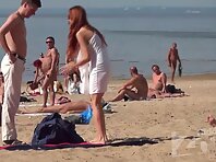 Nu2222#A young couple came to the beach. The red-haired girl began to take off her clothes. 