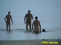 Nu1028#Company of nudists are swimming in the sea