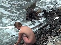 Nu1580#Nudists have a rest on the beach. They think that nobody sees and go completely naked