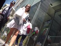 Up4114#Up the skirt of a tanned girl in a short white dress. Our cameraman managed to catch