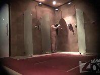 Sh1646#A woman is washing in the shower. In the opposite corner a hidden camera is installed