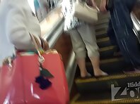 Up2846#Tanned blonde in a tight black skirt. Our cameraman managed to shoot her shaved crotc