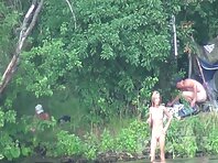 Nu1267#In the picture, there is another slim nudists. She tries to go into the water, but it