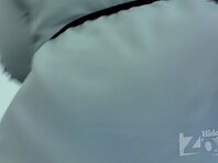 Up2461#Woman in short white dress. Our man managed to stick his hand with the camera to her 