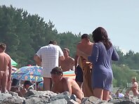 Nu1373#The couple came to the nudist beach. Man quickly removed pants and began to look at n