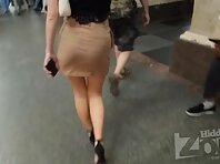 Up4412#Upskirting a girl in a short beige skirt. Our cameraman managed to slip his hand unde