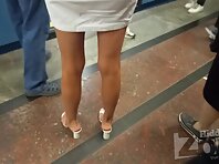 Up2992#Upskirt to tanned beauty in a short white dress. The girl climbed the steps. Great up