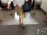 Up2930#Upskirt brunette in a long beige skirt. Our operator brazenly put his hand with the c