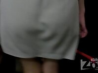 Up1872#A slender girl in a short white skirt. Our operator was able to film her shaved crotc