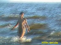 Nu1038#Nude beach voyeur video! A beautiful naked girl is swimming and sunbathes