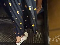 Up2876#Under the skirt of a slender brunette in a short green dress. Our cameraman filmed on