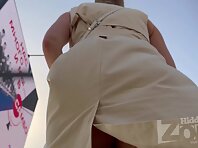 Up4461#Under the skirt of a girl in a beige dress. Our cameraman managed to catch her round