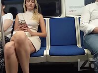 Up4446#Under the skirt of a blonde in a short beige dress. Her pubic area and shaved crotch,