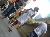 Up4172#Upskirt of a tanned girl in a white sundress. Our cameraman caught a close-up of her
