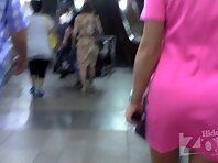 Up2924#Under the skirt of a tanned blonde in a short pink dress. Beautiful tanned thighs and