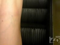 Up2449#Upskirt a slender girl in a short blue dress. Beautiful tanned thighs and shaved crot