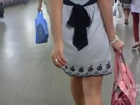 Up4452#Up the skirt of a tanned girl in a short gray dress. Our cameraman repeatedly slipped