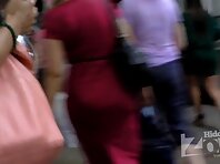 Up2477#Upskirt a tanned brunette in a short white skirt. Our operator photographed on her hi