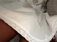 Up3008#Under the skirt of a tanned brunette in a white sundress. The lens of our hidden came