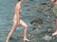 Nu2107#Pretty brunette basking in the coastal waves. We can clearly see her resilient tits a