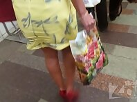 Up2518#Upskirt with a tanned brunette in a yellow dress. Our operator several times pushed h