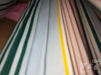 Up2891#Upskirt slim tanned girl in a long multi-colored skirt.