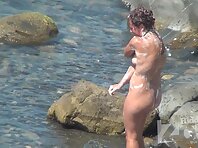 Nu1286#Young naked babe is washed by the sea. She lathers her gorgeous body and washes it wi