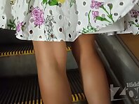 Up4111#Upskirt of a tanned blonde in a white dress. Our cameraman repeatedly slipped his han