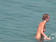 Nu1458#A new girl came to the beach. She immediately took off her clothes and went to bathe.